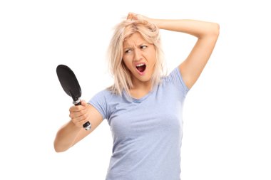 woman looking herself in a mirror