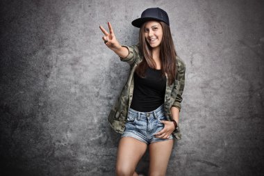 Teenage girl making a peace sign