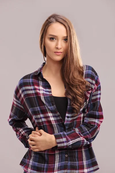 Beautiful brunette woman in checkered shirt — Stock fotografie