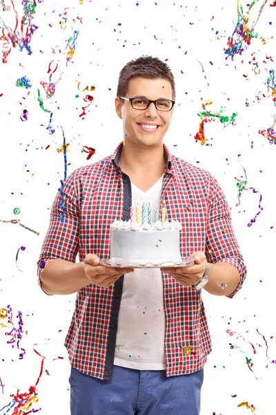 Young man carrying a birthday cake — Stock Photo, Image