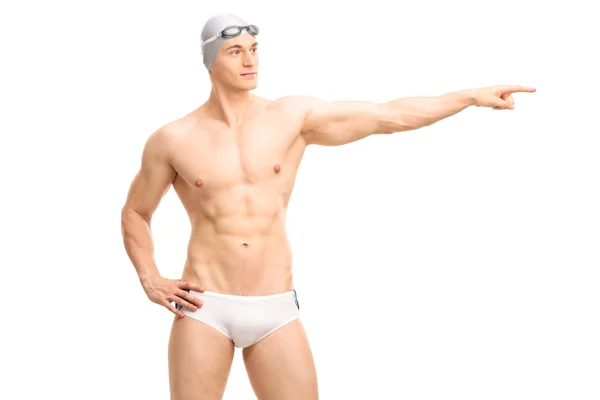 Junge hübsche Schwimmerin zeigt mit der Hand — Stockfoto