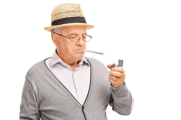 Hombre mayor encendiendo un porro — Foto de Stock