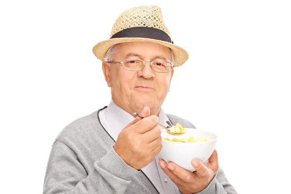 Senior gentleman eating cereal — Stok fotoğraf