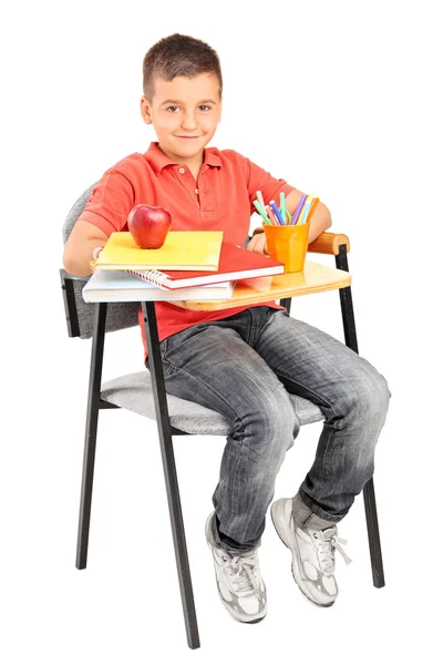 Schoolboy sitting at a school desk — Stock Photo, Image