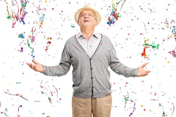 Senior gentleman in a bunch of confetti streamers — Stock fotografie