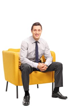 Confident businessman sitting in an armchair