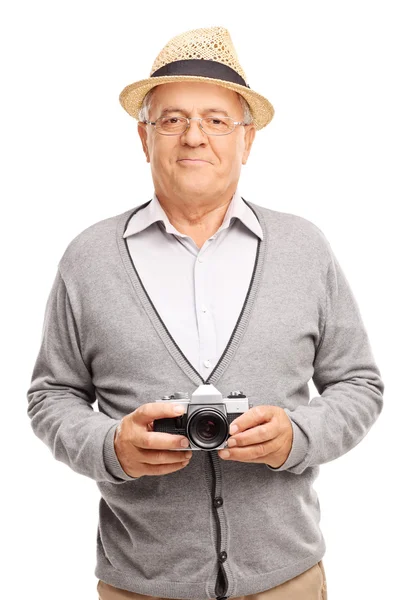 Senior gentleman holding a camera — Stok fotoğraf