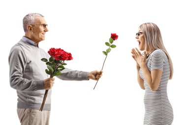 Yaşlı bir adam beyaz arka planda izole edilmiş genç bir kadına kırmızı gül veriyor.