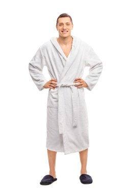 Cheerful young man in a white bathrobe clipart