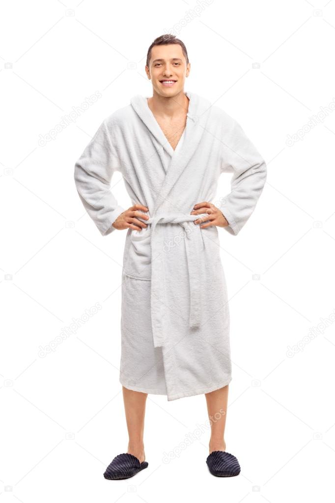 Cheerful young man in a white bathrobe