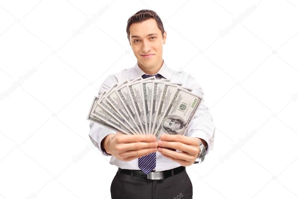 Confident businessman holding a stack of money