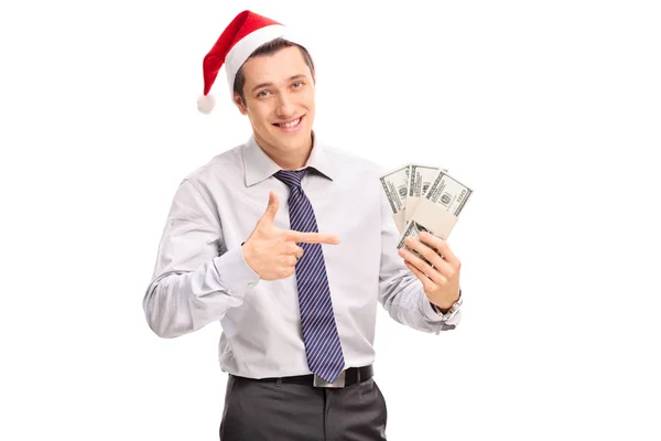 Geschäftsmann mit Weihnachtsmütze hält Geld in der Hand — Stockfoto