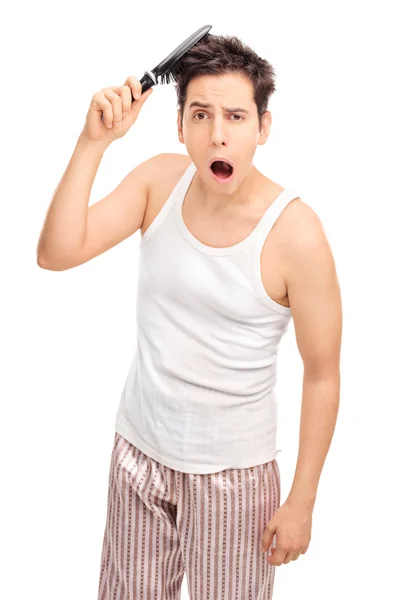 Sleepy guy combing his hair — Stock Photo, Image