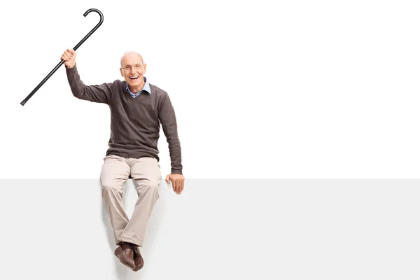 Senior gentleman sitting on a panel — Stock Photo, Image