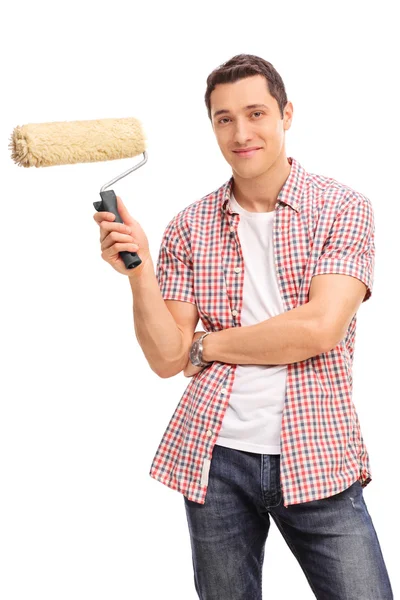 Young man holding a paint roller — Stock Photo, Image