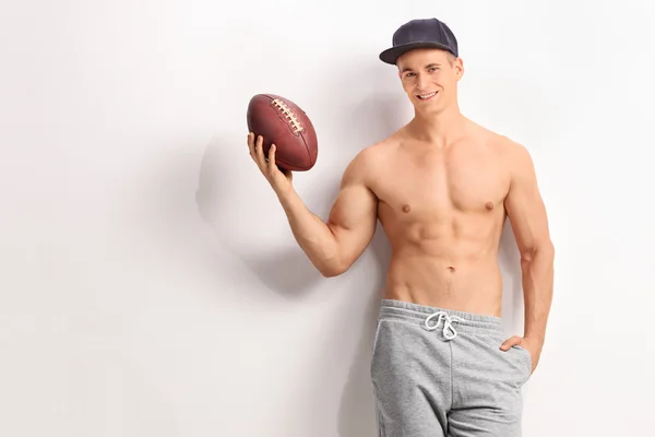 Handsome young man holding a football — Stock Photo, Image