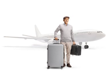 Senior man traveler with suitcases standing in front of an airplane isolated on white background