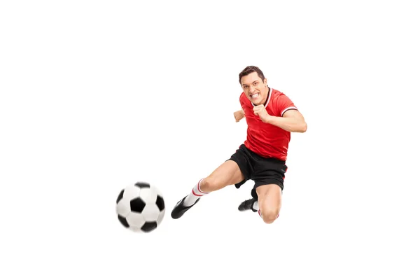 Young football player shooting a football — Stock Photo, Image