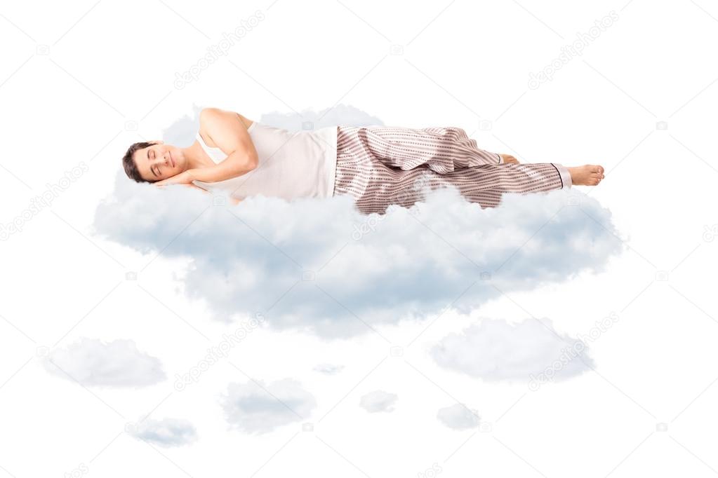 Young joyful man sleeping on a cloud