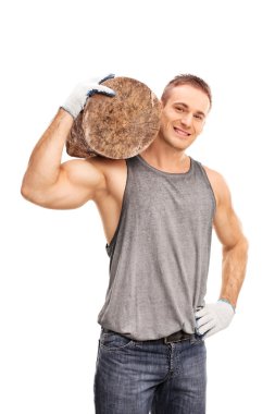 Young man carrying a heavy log