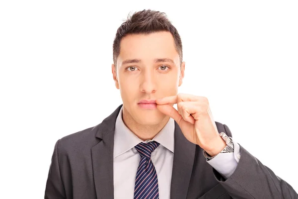 Businessman holding hand on his lips — Stockfoto