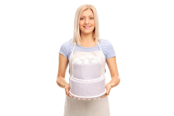 Female pastry chef carrying cake — Stok fotoğraf