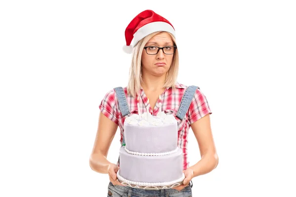 Sad woman holding a cake — Stockfoto