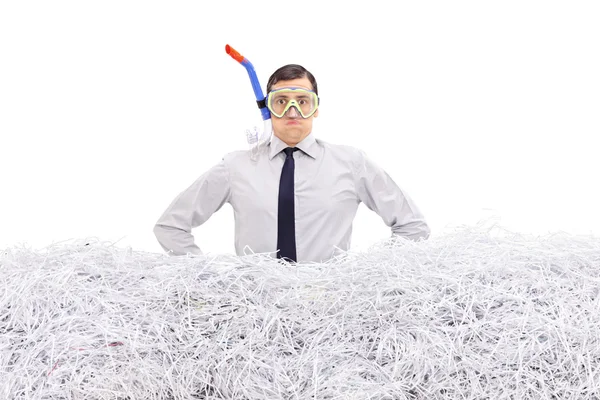 Businessman with snorkel standing in shredded paper — Zdjęcie stockowe