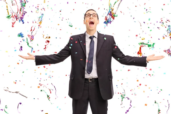 Overjoyed businessman with confetti around him — Stock fotografie
