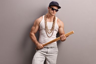 Muscular gangster holding a baseball bat 