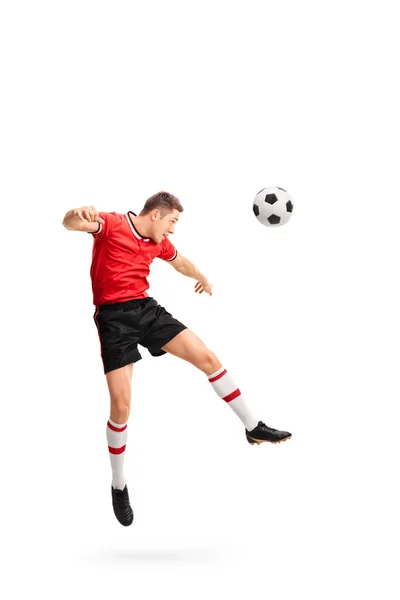 Young football player heading a ball — Stock Photo, Image