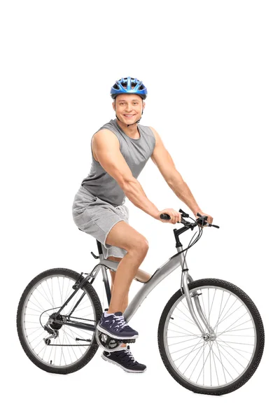 Man with a blue helmet sitting on bike — Zdjęcie stockowe