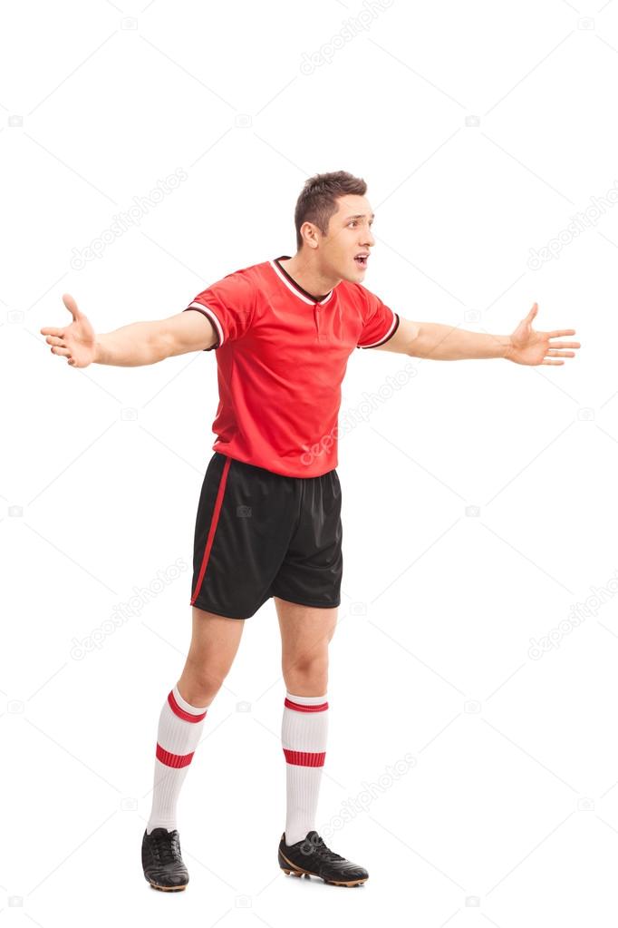 Displeased football player gesturing with his hands