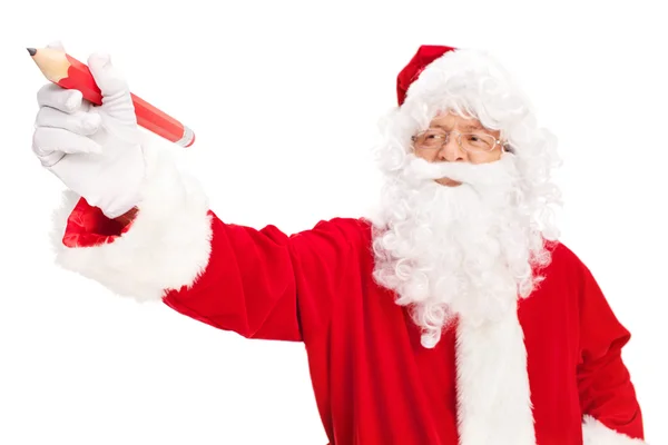 Papá Noel sosteniendo un enorme lápiz rojo — Foto de Stock