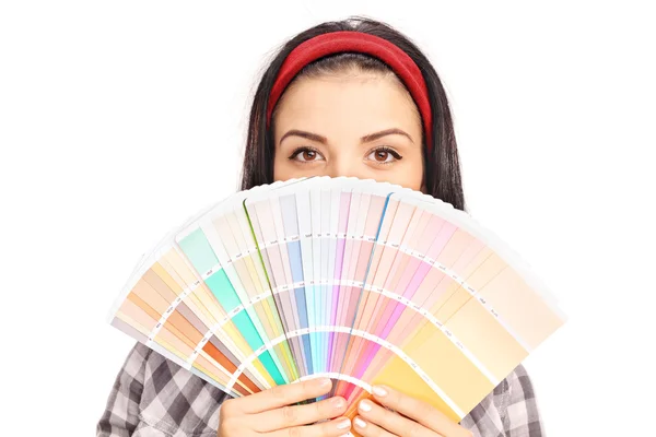 Woman hiding face behind a color swatch — Stock Photo, Image