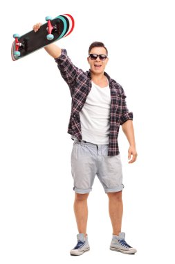 Excited skater holding his skateboard