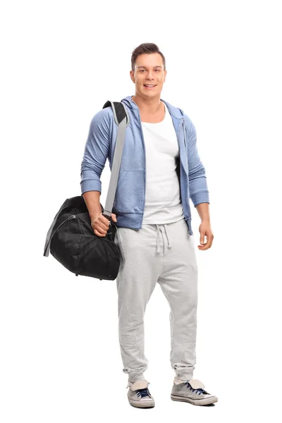 Young sportsman carrying a sports bag — Stock Photo, Image
