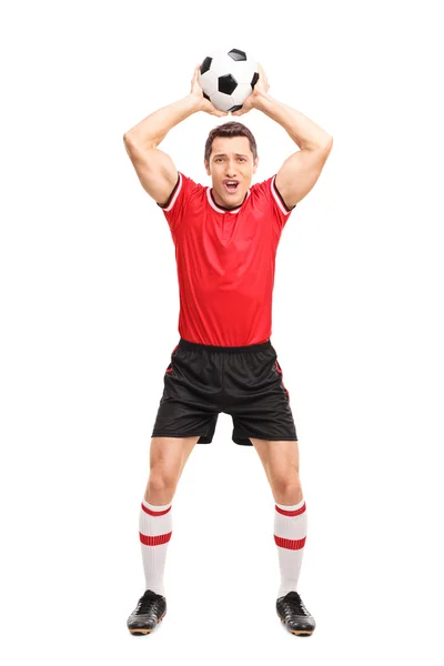 Young football player taking a throw-in — Stock Photo, Image