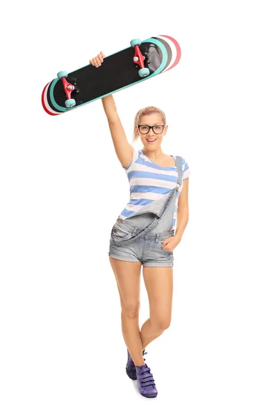 Young hipster girl holding a skateboard — Stock Photo, Image