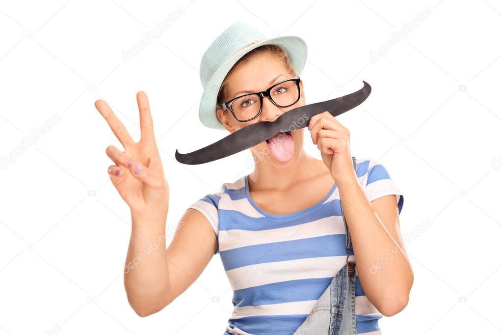 girl with fake mustache making a peace sign