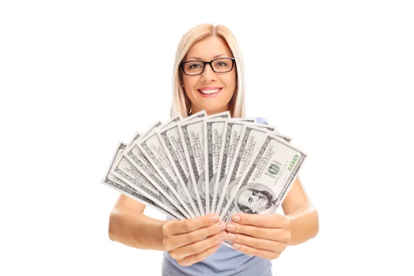 Young woman spreading a stack of money — Stockfoto