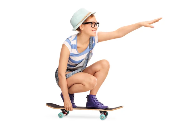 Hipster girl riding a skateboard — Stockfoto