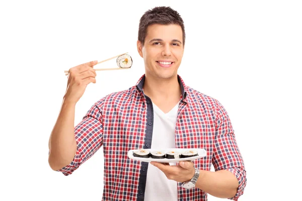 Man holding a piece of sushi — Stock Photo, Image