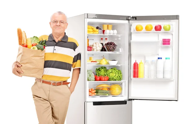 Mature man holding a grocery bag — Stock Photo, Image