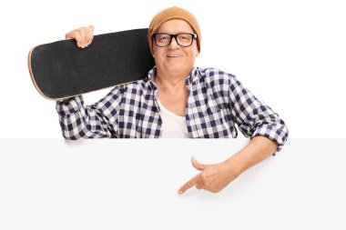 Mature man with skateboard behind a panel clipart