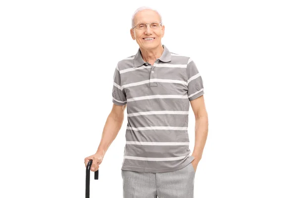 Senior man holding a cane and posing — Stock Photo, Image