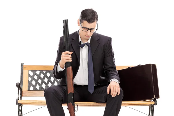 Depressed businessman holding a rifle — Stock Photo, Image