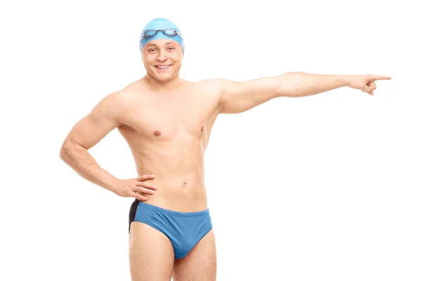 Handsome male swimmer pointing right — Stock Photo, Image