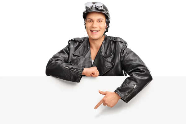 Bir reklam panosunun arkasına duran genç motorcu — Stok fotoğraf