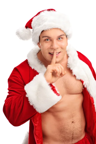Man in a Santa costume with finger on lips — Stock Photo, Image